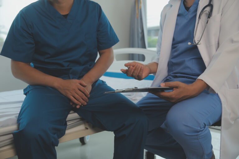 Professional orthopedist examining little patient's leg in clinic