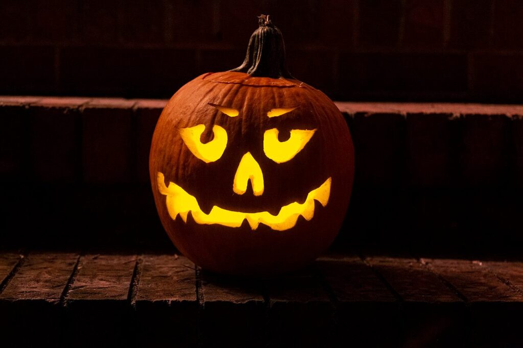 Greek Halloween party in London: a carved pumpkin glowing at night