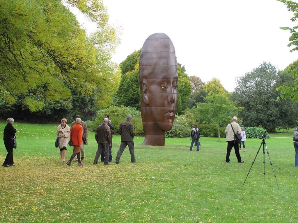 Visitors walking between sculptures at Frieze in Regent's Park, a short walk from Greek restaurants in Marylebone
