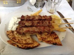 Greek street food in London: pork souvlaki skewers with pita, chips and tzatziki